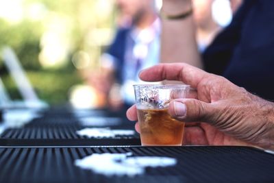 Cropped image of hand holding drink