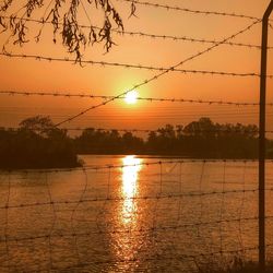 Scenic view of sea against orange sky