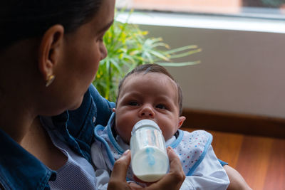 Father holding baby at home
