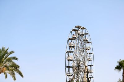 Low angle view of ferris wheel against clear sky