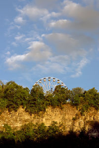 Low angle view of ferris wheel against sky