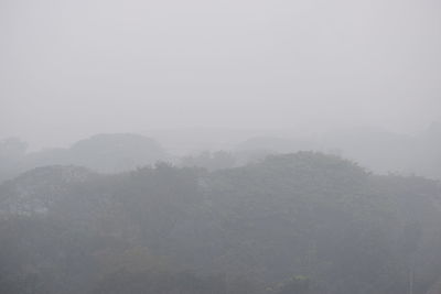 Scenic view of mountains in foggy weather