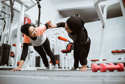 Rear view of man exercising in gym