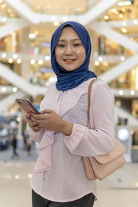 Portrait of smiling man using mobile phone