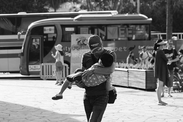 rear view, full length, lifestyles, casual clothing, men, street, leisure activity, walking, transportation, person, city, day, sidewalk, city life, mode of transport, focus on foreground, standing, outdoors