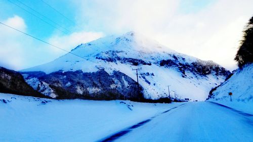 Scenic view of snowcapped mountains against sky