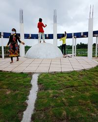 People on footpath against sky