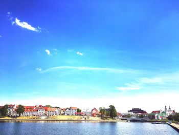 Scenic view of river against blue sky