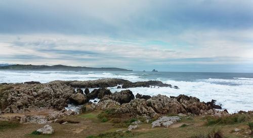 Rocks on beach against sky