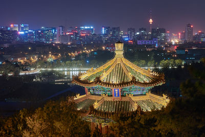 High angle view of illuminated buildings in city at night