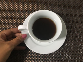 Midsection of coffee cup on table