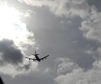 Low angle view of airplane flying in sky