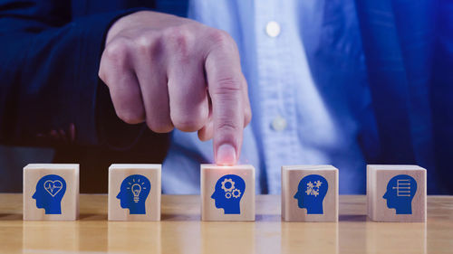 Midsection of businessman with toy blocks