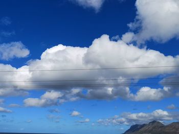 Low angle view of white clouds against blue sky