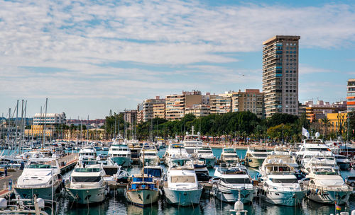 Boats moored at harbor in city