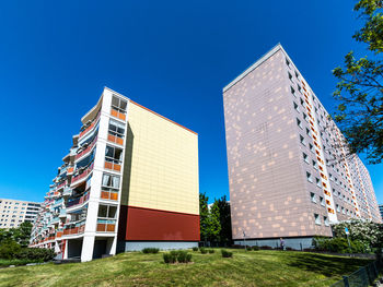 Low angle view of modern building against clear blue sky