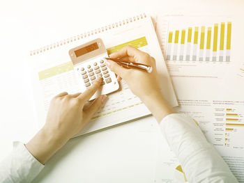 High angle view of woman reading book on table
