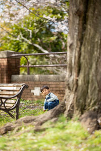Man sitting on tree trunk
