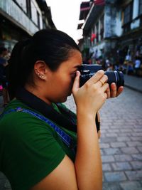 Close-up of child holding camera