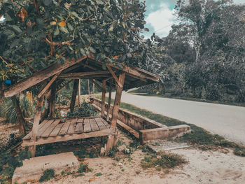 Wooden structure on field against sky