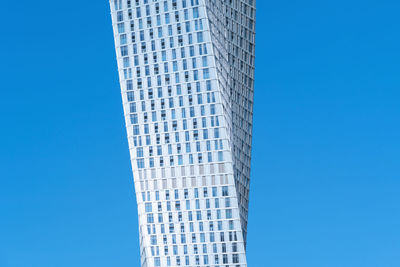 Low angle view of modern building against blue sky