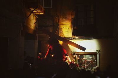 Rear view of man in illuminated stage at night