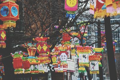 Close-up of lanterns hanging on street in city