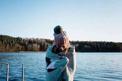 Woman wrapped in a towel after cod water ice swimming in the sea