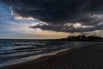 Scenic view of beach against sky during sunset