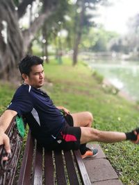 Mature man sitting on bench in park