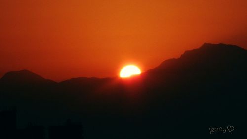 Scenic view of silhouette mountain against sky during sunset