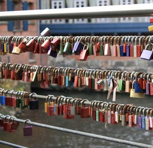 Padlocks hanging on railings in city