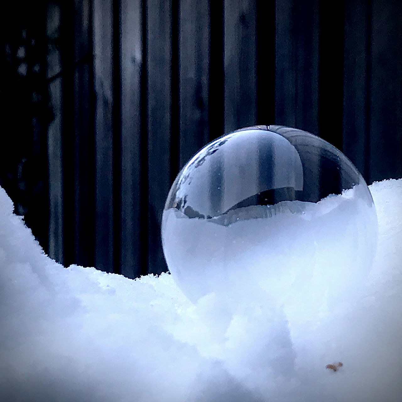 CLOSE-UP OF WHITE CRYSTAL BALL ON SNOW COVERED LAND
