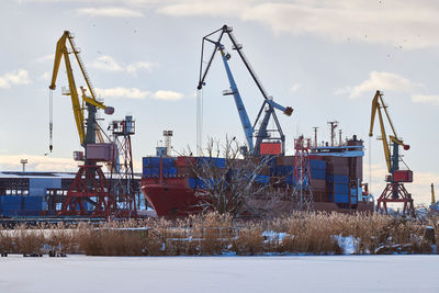 Moored cargo ships and harbor cranes in port. seaport, cargo container yard, container shipyard