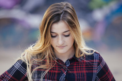 Portrait of young woman looking away outdoors