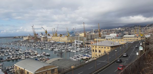 High angle view of city by sea against sky