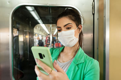 Portrait of young woman holding train