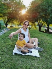 Mother and son sitting at park
