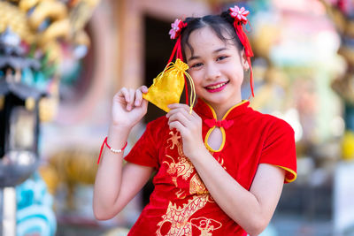 Portrait of smiling girl holding bag