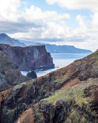 Scenic view of sea and mountains against sky