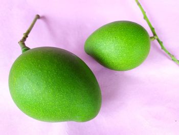 Close-up of green fruits on table