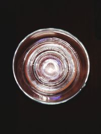 Directly above shot of glass against black background