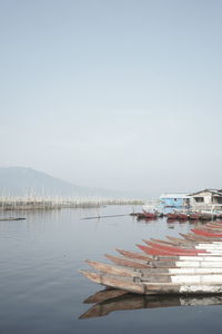 Boats in sea against clear sky