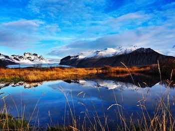 Scenic view of lake and mountains against sky