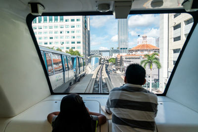 Rear view of people traveling in bus