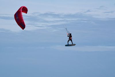 Low angle view of person paragliding
