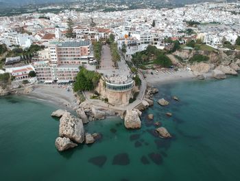 High angle view of townscape by sea