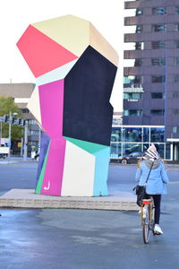 Man with umbrella walking on road