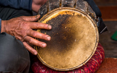 Midsection of man playing guitar