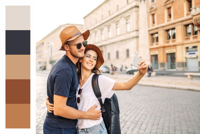 Young woman using mobile phone while standing in city